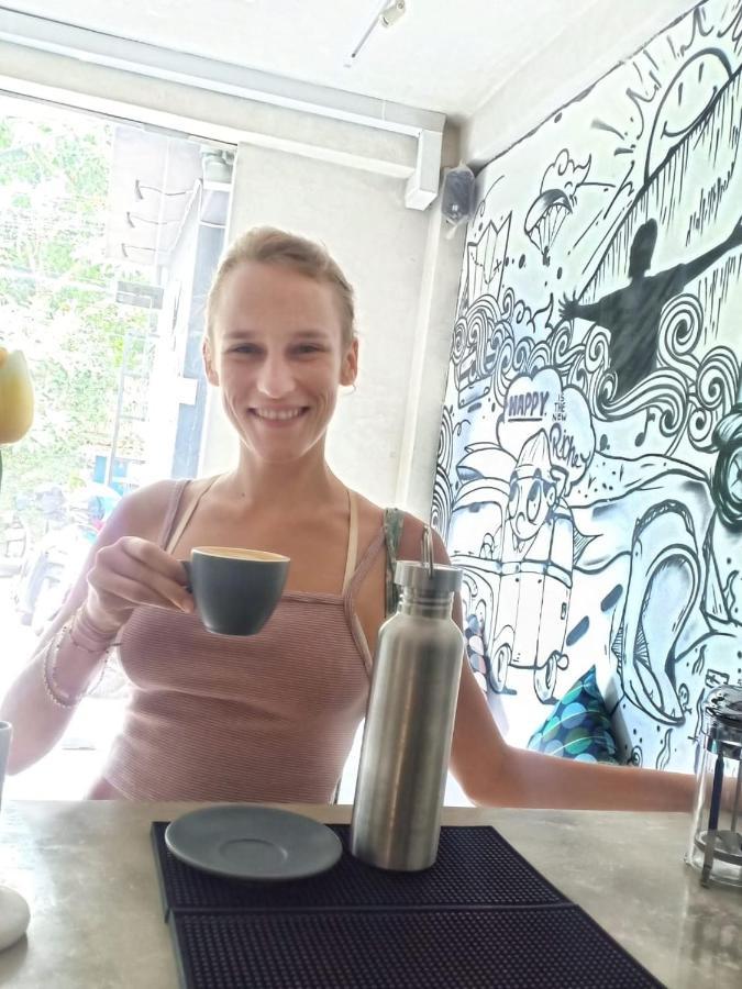 Stellar Capsules Hostel Seminyak Kültér fotó A woman drinking coffee